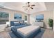 Staged primary bedroom features a tray ceiling and coastal decor at 196 Boulder Run, Hiram, GA 30141