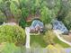 Aerial view of a red brick house with a pool, surrounded by lush greenery and mature trees in a serene setting at 250 Chason Wood Way, Roswell, GA 30076