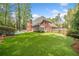 Brick home features a backyard with artificial turf, mature trees, and an in-ground pool at 250 Chason Wood Way, Roswell, GA 30076