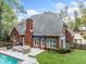 Exterior: Enjoy an outdoor space with an in-ground pool, a stone patio, and a lawn at 250 Chason Wood Way, Roswell, GA 30076