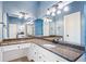 Bathroom with granite countertops, white cabinetry, large mirror, and decorative lighting at 250 Chason Wood Way, Roswell, GA 30076