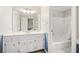 Bathroom features a large mirror, vanity with white countertop and cabinets, and a shower and bathtub combo at 250 Chason Wood Way, Roswell, GA 30076