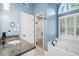 Stylish bathroom with granite counters, shower, and tub offers a relaxing retreat at 250 Chason Wood Way, Roswell, GA 30076