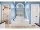 Spa-like bathroom features a soaking tub, granite countertops, and a separate glass shower at 250 Chason Wood Way, Roswell, GA 30076