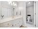 Bathroom with a vanity with white cabinetry and gold hardware at 250 Chason Wood Way, Roswell, GA 30076