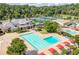 Community pool area featuring swimming lanes, a splash pad, and tennis courts in the background at 250 Chason Wood Way, Roswell, GA 30076