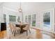 Cozy dining area features a rustic wood table, neutral chairs, and views of the backyard pool at 250 Chason Wood Way, Roswell, GA 30076