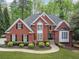 Beautiful brick home with manicured lawn, double front door, and mature landscaping gives great curb appeal at 250 Chason Wood Way, Roswell, GA 30076
