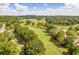 Verdant golf course meanders through mature trees with homes lining the perimeter at 250 Chason Wood Way, Roswell, GA 30076