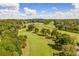 Picturesque golf course with rolling greens, mature trees, and a glimpse of the community clubhouse at 250 Chason Wood Way, Roswell, GA 30076