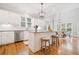 Eat-in kitchen featuring white cabinets, a center island and stainless steel appliances at 250 Chason Wood Way, Roswell, GA 30076