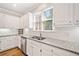 Modern kitchen features granite countertops, stainless steel appliances, and white cabinets at 250 Chason Wood Way, Roswell, GA 30076