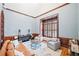 Cozy living room with a leather couch, gray chairs, wood trim, and a large window at 250 Chason Wood Way, Roswell, GA 30076