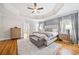 Spacious main bedroom features a tray ceiling, hardwood floors, and ensuite bathroom access at 250 Chason Wood Way, Roswell, GA 30076