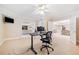 Home office with neutral carpet, a ceiling fan, and view through the doorway to the living room and dining room at 250 Chason Wood Way, Roswell, GA 30076