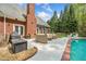 Brick home features an outdoor lounge area with a grill and outdoor dining at 250 Chason Wood Way, Roswell, GA 30076