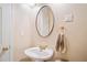 Charming powder room features a pedestal sink, round mirror, and stylish fixtures at 250 Chason Wood Way, Roswell, GA 30076