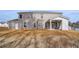Large backyard with a two-story brick house and covered patio at 520 Dulles Dr, Mcdonough, GA 30253
