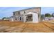 Large backyard with a two-story brick house and covered patio at 520 Dulles Dr, Mcdonough, GA 30253