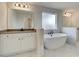 Bright bathroom featuring a soaking tub, dual sinks, and lots of natural light at 520 Dulles Dr, Mcdonough, GA 30253