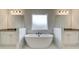 Luxurious bathroom featuring a freestanding tub, dual sinks, and elegant marble accents at 520 Dulles Dr, Mcdonough, GA 30253