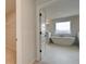 En-suite bathroom with soaking tub next to a walk-in closet and natural light at 520 Dulles Dr, Mcdonough, GA 30253