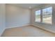 Bright and airy bedroom features two large windows and light hardwood floors at 520 Dulles Dr, Mcdonough, GA 30253