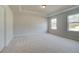 Neutral bedroom with recessed ceiling, two windows, and plush carpeting at 520 Dulles Dr, Mcdonough, GA 30253
