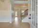 Bright foyer with hardwood floors, a staircase with rod iron spindles, and wainscoting at 520 Dulles Dr, Mcdonough, GA 30253