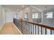 Upstairs hallway with hardwood floors and wrought iron at 520 Dulles Dr, Mcdonough, GA 30253