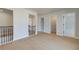 Hallway features wood floors, access to storage closet, and black doorknobs at 520 Dulles Dr, Mcdonough, GA 30253