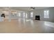 Open concept living room and kitchen with hardwood floors, fireplace, and natural light at 520 Dulles Dr, Mcdonough, GA 30253