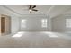 Spacious main bedroom with tray ceiling, ceiling fan and lots of natural light at 520 Dulles Dr, Mcdonough, GA 30253