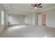 Large main bedroom features a tray ceiling, ceiling fan and neutral colored carpet at 520 Dulles Dr, Mcdonough, GA 30253
