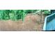 Panoramic view of the private backyard with a fire pit and lush greenery at 1230 Sunderland Ne Ct, Brookhaven, GA 30319