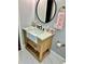 Farmhouse bathroom featuring a wood vanity with a white countertop and stylish fixtures and circular mirror at 1230 Sunderland Ne Ct, Brookhaven, GA 30319