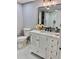 Charming bathroom showcasing a marble countertop vanity, toilet, and decorative flower arrangement at 1230 Sunderland Ne Ct, Brookhaven, GA 30319