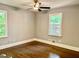 Cozy bedroom with hardwood floors, neutral walls, a ceiling fan, and bright natural light at 1230 Sunderland Ne Ct, Brookhaven, GA 30319