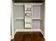 Walk-in closet with built-in shelving and organization system over hardwood floors at 1230 Sunderland Ne Ct, Brookhaven, GA 30319
