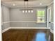 Elegant dining room with hardwood floors, stylish lighting, and neutral wall colors at 1230 Sunderland Ne Ct, Brookhaven, GA 30319