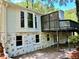 Back exterior featuring a painted brick foundation, upper deck, and walkout basement area at 1230 Sunderland Ne Ct, Brookhaven, GA 30319