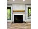 Close up of fireplace with wood mantel and large windows and door at 1230 Sunderland Ne Ct, Brookhaven, GA 30319