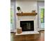 Beautiful fireplace with white shiplap surround, wood mantle, and access to outdoor deck at 1230 Sunderland Ne Ct, Brookhaven, GA 30319