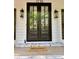 Elegant double front doors with glass panels, accented by stylish lanterns and a 'welcome' mat at 1230 Sunderland Ne Ct, Brookhaven, GA 30319