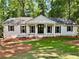 Charming one-story home with white siding, dark shutters, and a well-manicured front yard at 1230 Sunderland Ne Ct, Brookhaven, GA 30319
