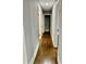 Long hallway with hardwood floors and doors to multiple rooms at 1230 Sunderland Ne Ct, Brookhaven, GA 30319
