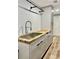 Close up of the laundry room's utility sink, wood countertops and gray cabinets at 1230 Sunderland Ne Ct, Brookhaven, GA 30319