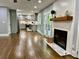 Open concept living room with hardwood floors, fireplace, and view of kitchen at 1230 Sunderland Ne Ct, Brookhaven, GA 30319