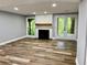 Living room featuring a fireplace, and windows overlooking the backyard at 1230 Sunderland Ne Ct, Brookhaven, GA 30319