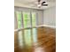 Main bedroom with large bay window offering outdoor view and hardwood flooring at 1230 Sunderland Ne Ct, Brookhaven, GA 30319